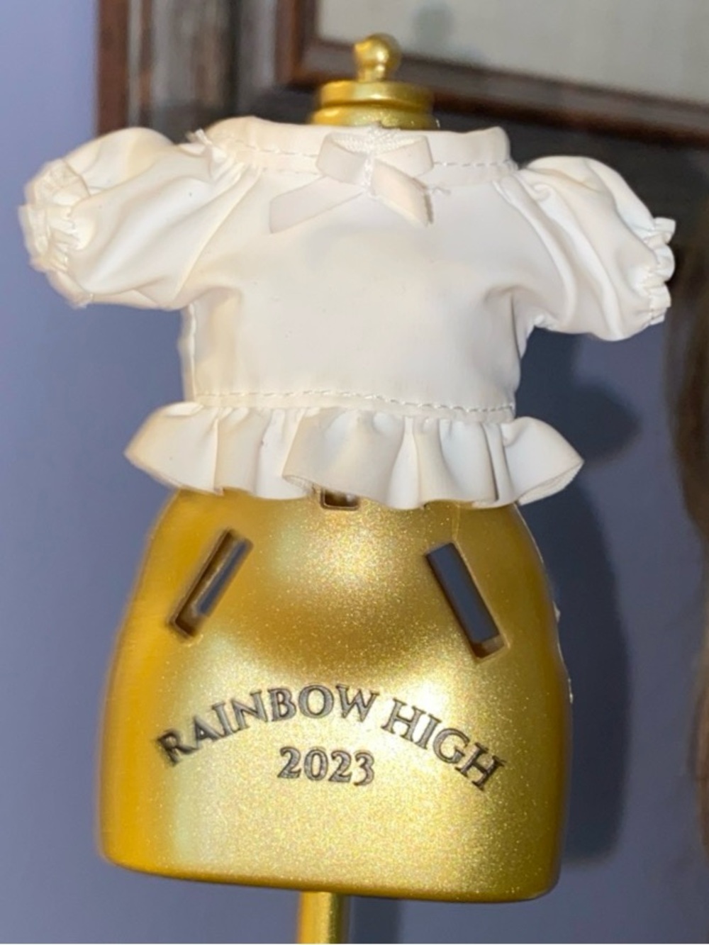 This Rainbow High doll top features a white blouse with puff sleeves and a ruff